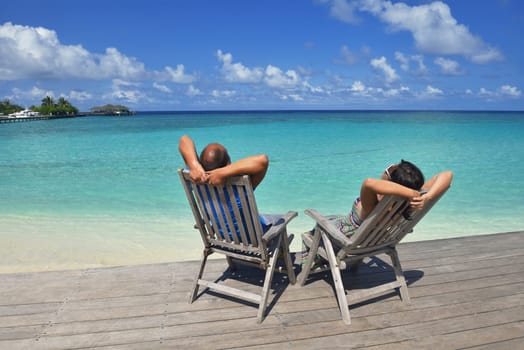 happy young couple have fun and relax at summer vacation on background maldives travel location and beautiful white sand beach