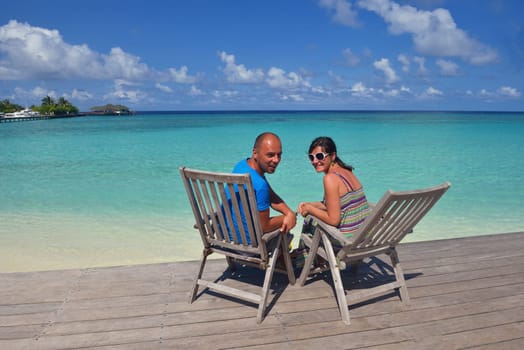 happy young couple have fun and relax at summer vacation on background maldives travel location and beautiful white sand beach