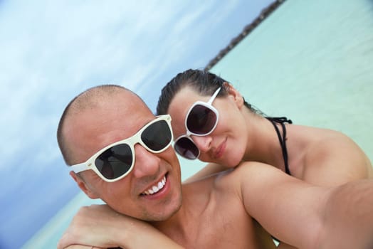 happy young couple have fun and relax at summer vacation on background maldives travel location and beautiful white sand beach
