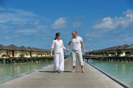 happy young couple have fun and relax at summer vacation on background maldives travel location and beautiful white sand beach