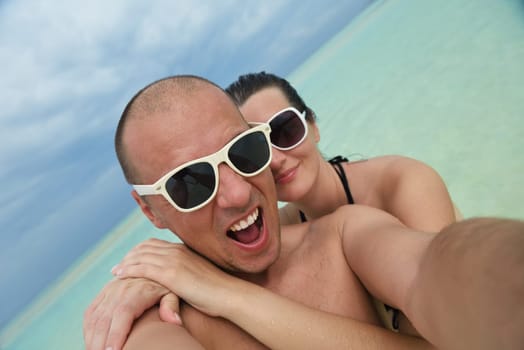 happy young couple have fun and relax at summer vacation on background maldives travel location and beautiful white sand beach