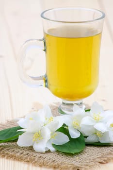 glass of jasmine tea and jasmine flowers