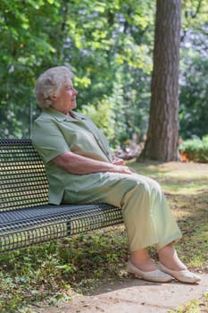 Elderly lady sitting on a bench