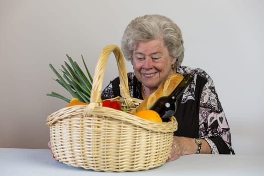 Elderly lady looks at her shopping basket