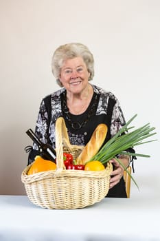 Elderly lady looks at her shopping basket