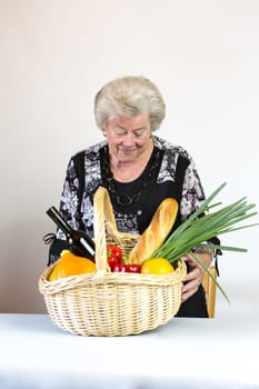 Elderly lady looks at her shopping basket