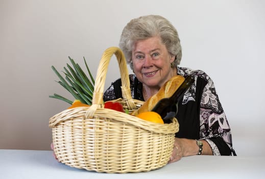 Elderly lady looks at her shopping basket
