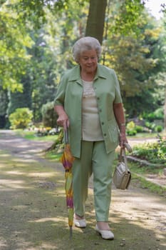 Elderly lady strolling through a park