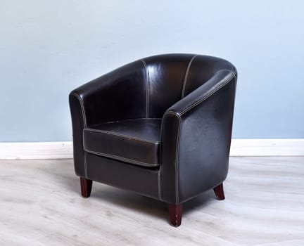Stylish black leather armchair in a modern room