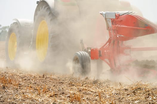 Tractor plowing the field. Agricultural work
