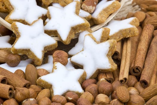 typical christmas cinnamon star cookies, nuts and cinnamon sticks