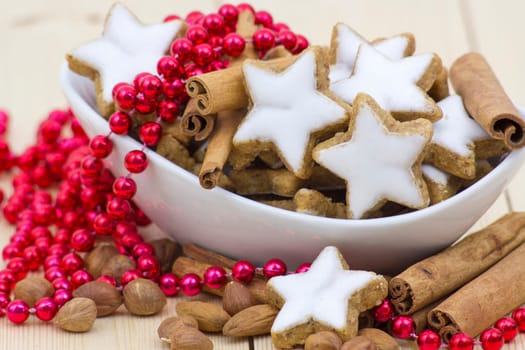 typical christmas cinnamon star cookies, nuts and cinnamon sticks