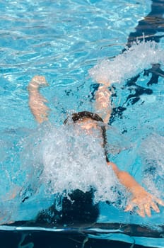 girl diving into swimming pool