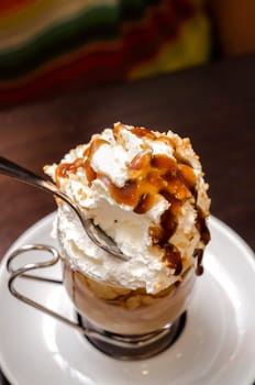 coffee with cream and caramel in the saucer
