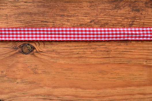 a black heart red rarized bow on wooden background