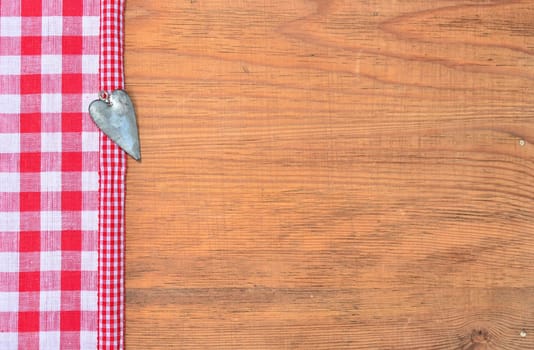 a black heart red rarized bow on wooden background
