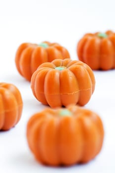 Colorful group of halloween candy in shape of pumpkins on white background. Also useful as autumn concept.