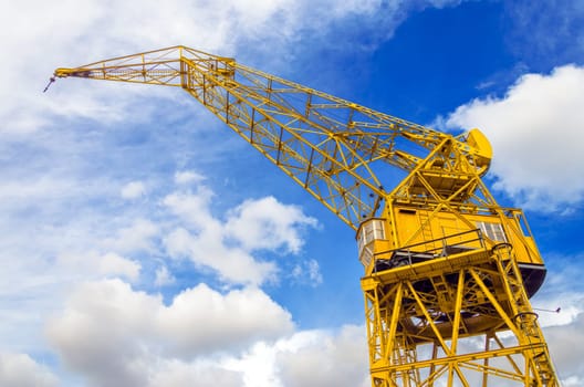 Old yellow crane and sky in Puerto Madero neighborhood of Buenos Aires, Argentina