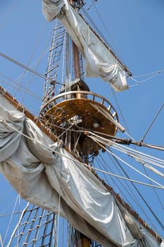 High mast with collected sails at windy day