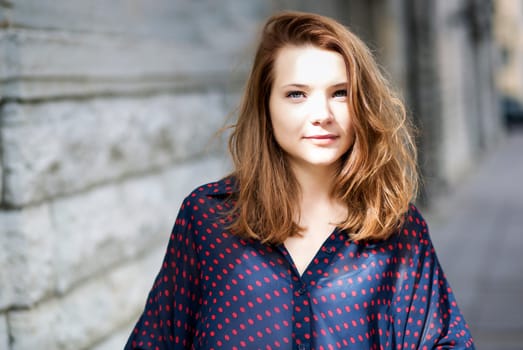 Zoomed young woman face with soft eyes look