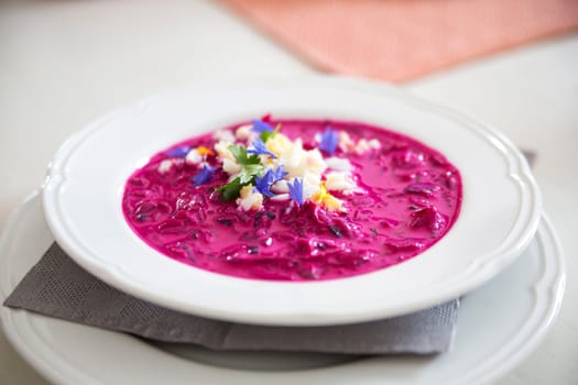 Round plate with hot soup maded from beet