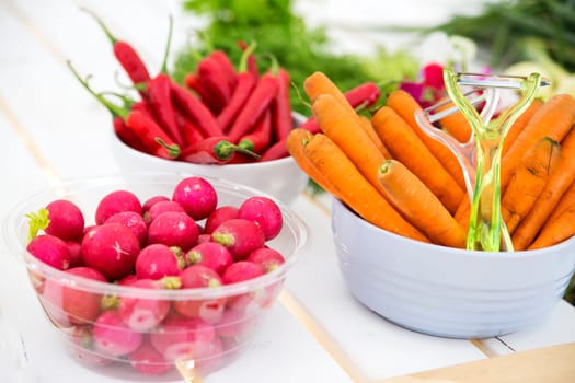 Vegetables as radish, carrot and chile in bowls