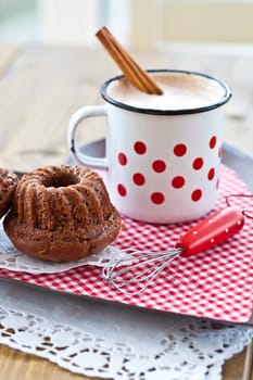 Hot chocolate in vintage cup with small chocolate cake