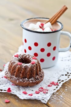Small Gugelhupf and a cup of hot chocolate with marshmallows