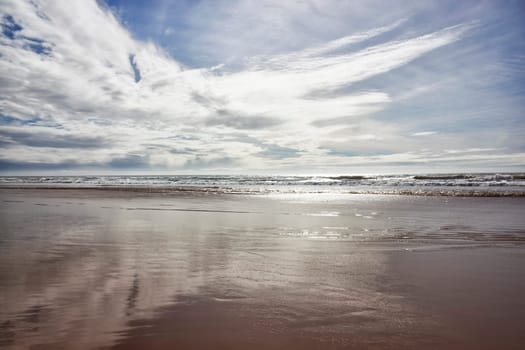 Beach with cloudy blue sky in Agadir at the Atlantic coast, Morocco.