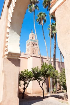 Koutoubia mosque with palms against clear blue sky, Marrakesh