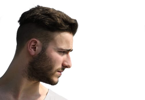 Portrait, profile shot of young man's face looking to a side, isolated on white