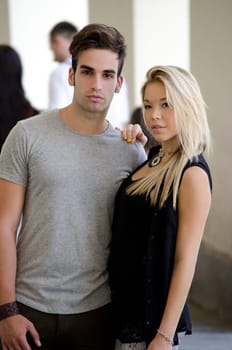 Attractive couple, young man and girl standing next to each other