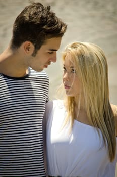 Romantic couple looking in each other's eyes outdoors
