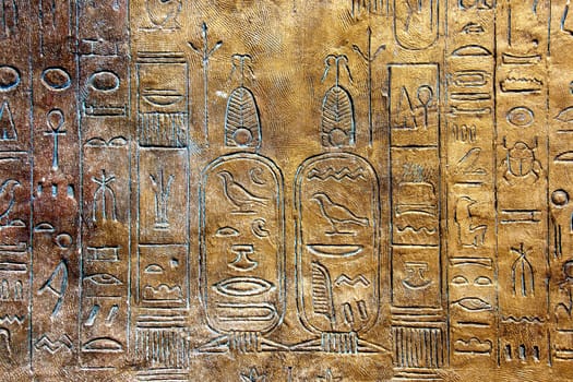 Ancient hieroglyphs on stone wall.