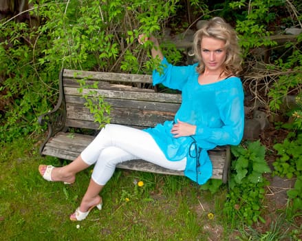 Young woman sitting on wooden bench