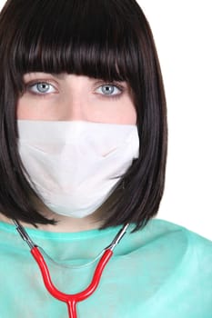 Woman in scrubs and medical mask