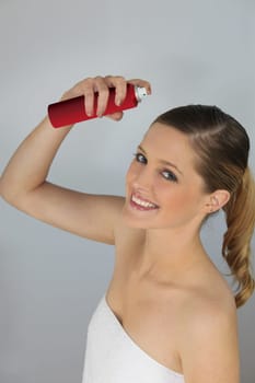 Woman using hair spray
