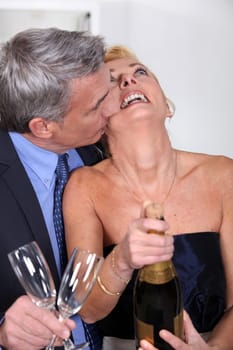 Couple popping a champagne cork