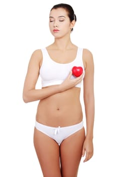 Happy Fit female in white sport underwear with red heart shaped toy