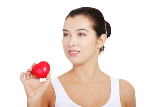 Happy Fit female in white sport underwear with red heart shaped toy