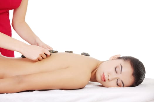 Beauty woman relaxing in spa. Stone massage.