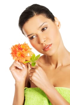 Portrait of beautiful young exotic woman with health skin and with flower