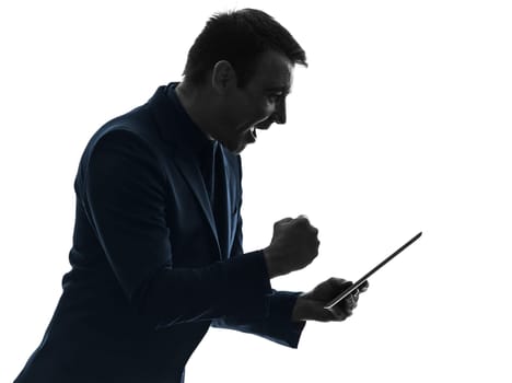 one caucasian business man holding digital tablet happy success  in silhouette on white background