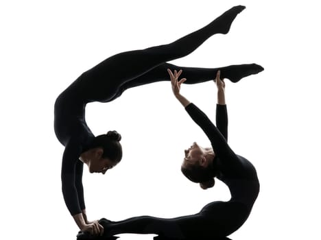 two women contortionist practicing gymnastic yoga in silhouette   on white background