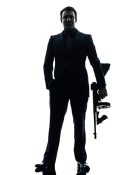 one caucasian man holding thompson machine gun  in silhouette on white background
