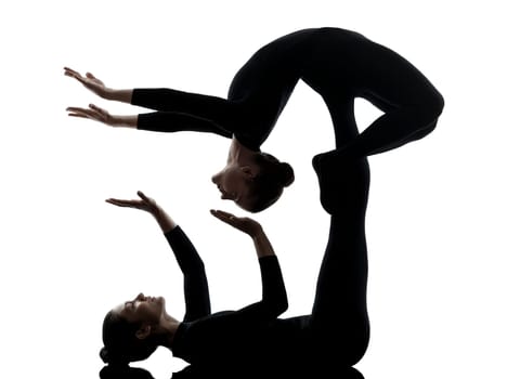 two women contortionist practicing gymnastic yoga in silhouette   on white background