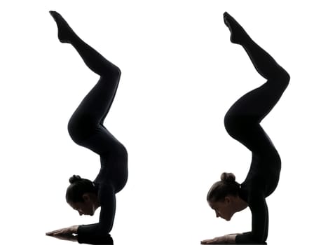 two women contortionist practicing gymnastic yoga in silhouette   on white background