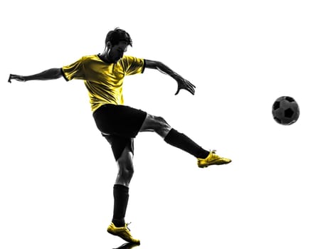 one brazilian soccer football player young man kicking in silhouette studio  on white background