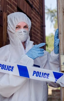 Crime scene investigator behind a police cordon
