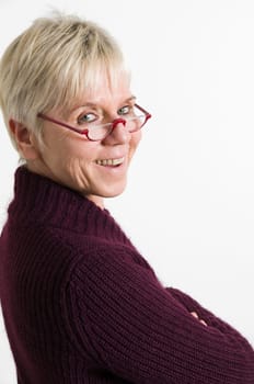 portrait of mature woman looking over shoulder at the camera  Portrait of an elderly woman looking over her shoulder